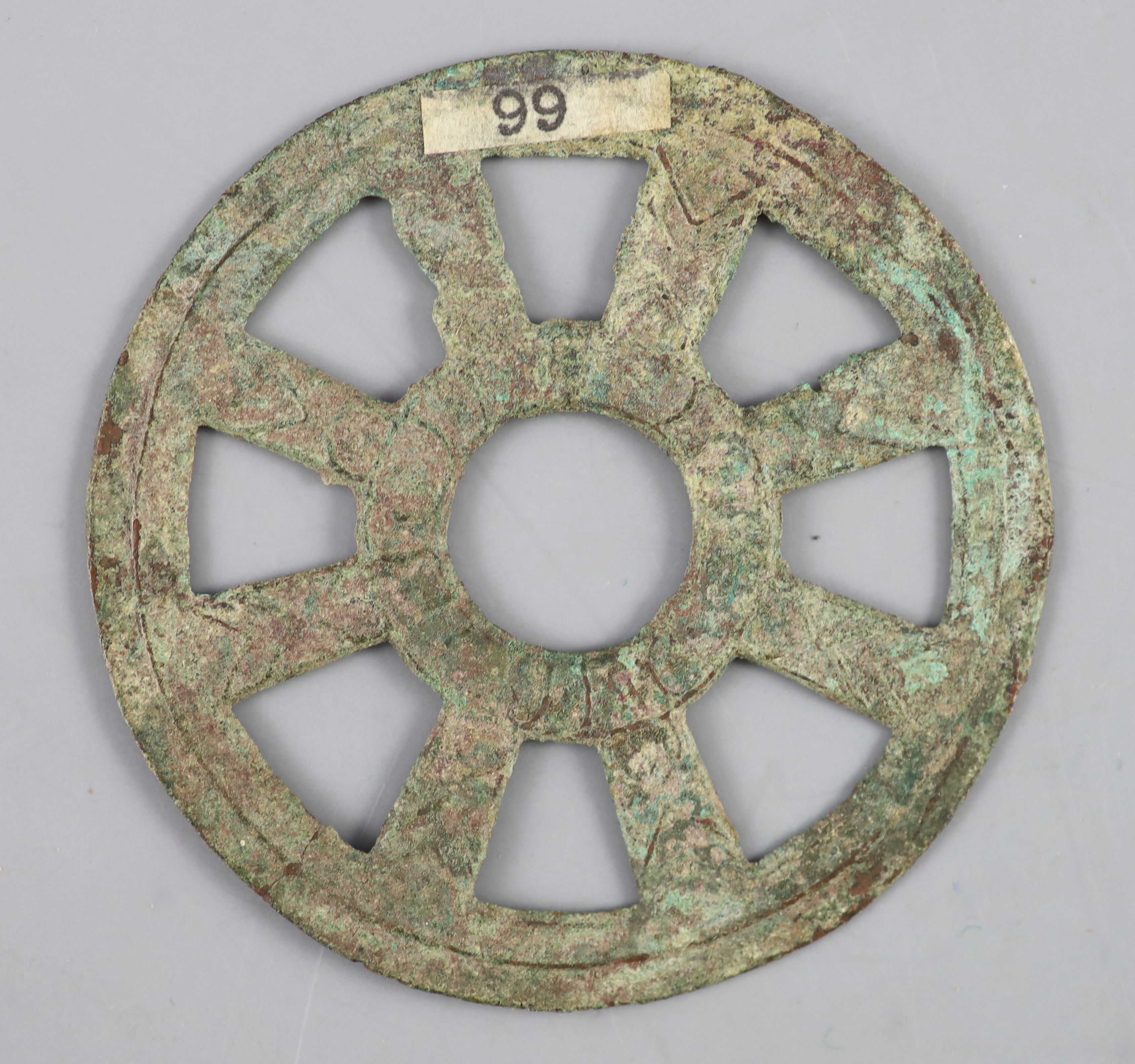 China, a rare archaic bronze openwork Dharmachakra (wheel) charm, probably Han-Tang dynasty,